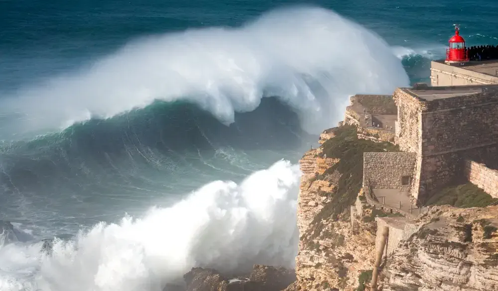 giant wave crashing into cliff, destination for portugal road trip
