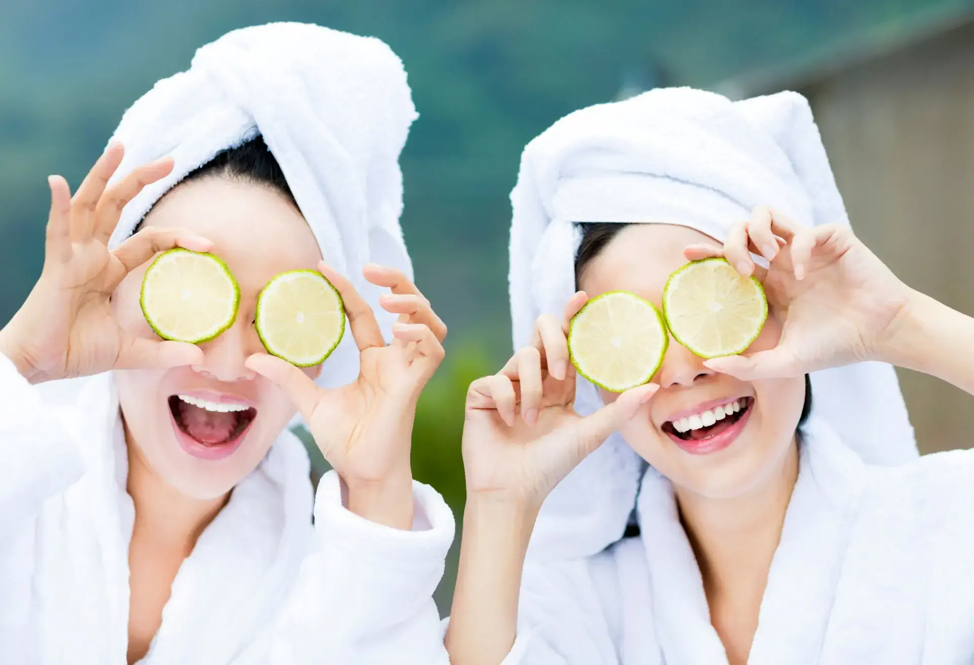 beautiful woman showing fresh lemon in spa