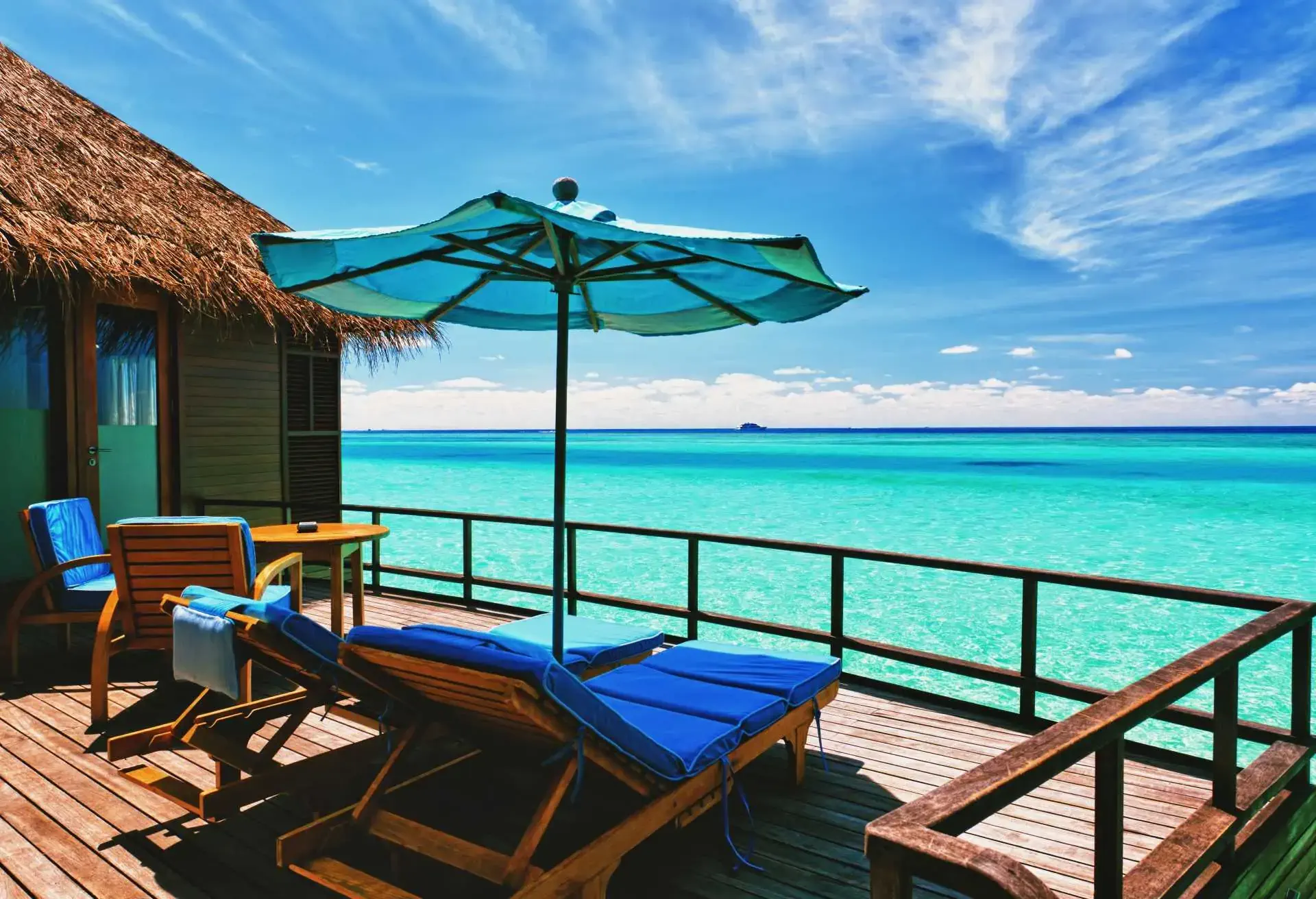 Overwater villa balcony overlooking tropical lagoon